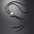 Close-up of vintage silver cowboy hat pendant with brown braided leather bolo tie cord - Dark Coffee Cowboy Hat