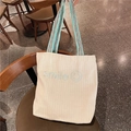Off-white corduroy tote bag with blue smile embroidery and woven shoulder strap - Green