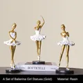 Three-piece set of gold and white resin ballet girl sculptures on black bases - Gold Ballet Girls Set