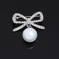 Silver bow brooch with sparkling crystals and a white round pearl pendant - Rhinestone Bowknot Silver Pearl