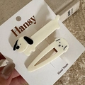 Close-up of handmade cream dog hair clips set on card with warm fabric background - 2-Pack Cartoon - White Dog