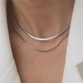 Minimalist double layer silver snake and box chain necklace worn with white suit - Silver