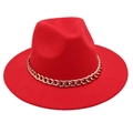 Detailed view of red fedora hat with elegant gold metal chain band on white background - Red