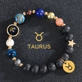 Macro shot of Taurus beaded bracelet with volcanic stone and celestial planet beads - Taurus