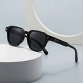 Retro black narrow frame sunglasses with gold metal accents on white geometric props - Black Frame Dark Gray Lens