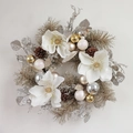 Christmas wreath featuring white magnolia flowers, pine cones, and festive silver ornaments - White Magnolia Wreath