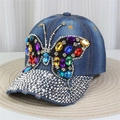 Close-up of a blue denim baseball cap featuring a large rhinestone butterfly and sequins - Style 28-Blue Denim Large Butterfly Rhinestone