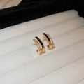 Minimalist gold hoop earrings featuring double rows with cubic zirconia on beige padding - Black