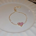 Detail of gold heart drawstring bracelet with pink zircon stone on white plate - Pink Heart Style (1#)