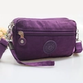 Purple nylon crossbody phone bag with multi-layer zippers and wrist strap in side view - Purple