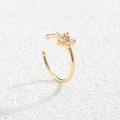 Detailed view of gold flower-shaped non-pierced nose clip with white zircon stones - Gold Small Flower Style (SE1185)