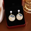 Detail of seashell floral earrings featuring pearls on black velvet jewelry box - Dark Blue Starfish Pearl Dangle