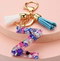 Close-up of resin letter Z keychain with colorful stones, gold ring and double tassels - Letter Z