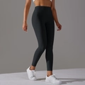 High-waisted black yoga pants with seamless design and elastic fabric for workout - Black