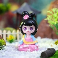 Cute ancient style panda figurine with pink floral headpiece in garden landscape - Sitting Meditating