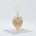 Macro detail of sphere evening bag featuring white pearls, gold rhinestones and long tassels - 17cm x 12.5cm x 29cm / Gold