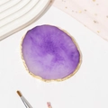 Detail of purple resin agate nail art palette with irregular gold edge on white background - Purple