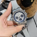 Detail of silver rhinestone bezel watch with grey rubber strap and blue accents - White Dial Blue Eye Gray Strap