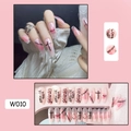 Detail of pink marble press-on nails with black hand-drawn graffiti and chain patterns - W010 Free Shackles