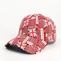 Close-up of red baseball cap featuring British flag graffiti and cotton twill texture - Adjustable / Red
