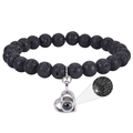 Close-up of black lava stone beads and silver heart pendant with I Love You projection - Lava Stone