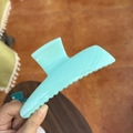 Detail of a large 13.5cm light blue matte shark hair claw clip held in hand - XL Butterfly Buckle (Approx. 13.5cm) / Xizi Cyan