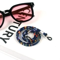 Detail of bohemian woven eyewear strap with adjustable rubber ends and silver metal tubes - US 3