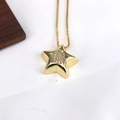 Close-up of gold star pendant with sparkling cubic zirconia letter G on snake chain - Letter G