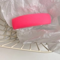 Detail of pink fabric sponge hair clip showing fine diagonal texture on white paper - Grapefruit Red