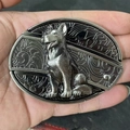 Close-up of a metal belt buckle featuring a detailed German Shepherd dog relief design - Dog