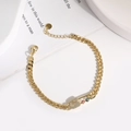 Pulsera de clip chapada en oro con amuleto de ojo turco y circonitas sobre mármol blanco - Ojo Turco Azul y Rojo (A)