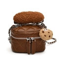 Brown quilted mini bucket bag with plush handle and cute cookie pendant on white background - Brown