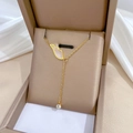Detailed view of titanium steel gold angel wing necklace in a premium beige gift box - Titanium Steel / Gold Style (N411 Gold)