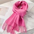Vibrant pink pure wool scarf with tassel fringe details on a white marble surface - Rose Pink