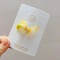 Close-up of a yellow butterfly hair clip with sheer tulle wings and sparkling rhinestones - Ginger Yellow