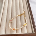 Baroque pearl bracelet featuring colorful beaded flowers and a gold adjustable clasp - White Flower Bracelet