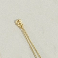 Macro shot of gold letter B pendant on a delicate chain with a polished metallic finish - Letter B(BXL2998)