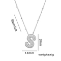 Silver 'S' initial necklace with micro-paved cubic zirconia on white background - Steel Color Letter S with Zirconia