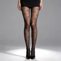 Detailed view of sheer black tights featuring elegant heart patterns and durable fabric - One Size (40-75kg) / Heart Print Black
