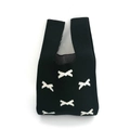 Detail shot of a black knitted bucket bag featuring white bow patterns on white background - Black Butterfly