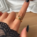 Unique golden frog ring in animal design worn on finger with black lace sleeve - KC Gold 0951