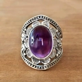 Macro view of vintage silver flower ring with purple oval stone and intricate filigree - US 6 / Purple