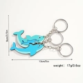 Detail view of wooden dolphin family keychains showing size metrics and cute cartoon patterns - Dolphin Family of Three