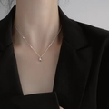 Elegant S925 sterling silver teardrop necklace with polished finish worn by a model - 925 Silver / White Gold