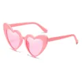 Fashion heart shaped sunglasses with bright pink frames and metal hinges in color C11 - Pink Frame / Pink Lens