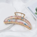 Detail of crescent hair claw clip with pink and blue acetate inlay on a gold metal frame - Blue Pink