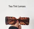 Detail of tortoise frame sunglasses with tea lenses held against a neutral background - Tortoise Frame Tea Lens