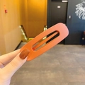Matte orange large square hollow hair claw clip held in hand for women style - Caramel color