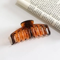 Large amber brown translucent hair claw clip made of resin for elegant hair styling - Tortoise Shell