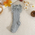 Detail of grey knitted baby knee-high socks with a large velvet bow on a cozy background - Gray / Xs 0-1